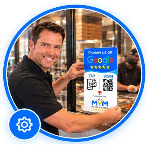 A team member installing a My Voice Matters review sign on a restaurant door